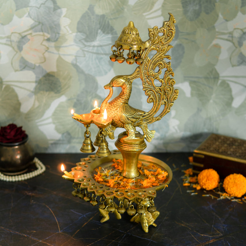 Brass peacock parrot Diya - exquisitely crafted brass oil lamp in the shape of a peacock with parrot motifs, golden finish, decorative home accent, fusion of elegance and vibrancy, traditional Indian Diya, emits a captivating and auspicious glow, perfect for festive occasions and religious ceremonies, enhances spiritual ambiance and decor with a touch of artistic brilliance.