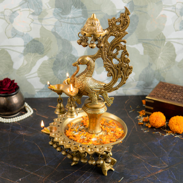 Brass peacock parrot Diya - exquisitely crafted brass oil lamp in the shape of a peacock with parrot motifs, golden finish, decorative home accent, fusion of elegance and vibrancy, traditional Indian Diya, emits a captivating and auspicious glow, perfect for festive occasions and religious ceremonies, enhances spiritual ambiance and decor with a touch of artistic brilliance.