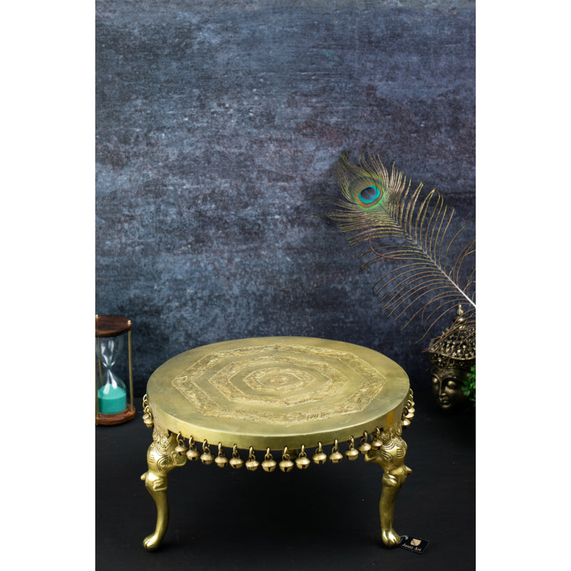 Brass Chowki - intricately carved brass platform, golden finish, perfect for placing deities or sacred objects during religious ceremonies and rituals, enhances the sanctity and beauty of the worship space, symbolizes stability and divine presence, adds a touch of elegance to your home puja setup, a valuable and ornamental addition to your collection of brass religious artifacts and decor.