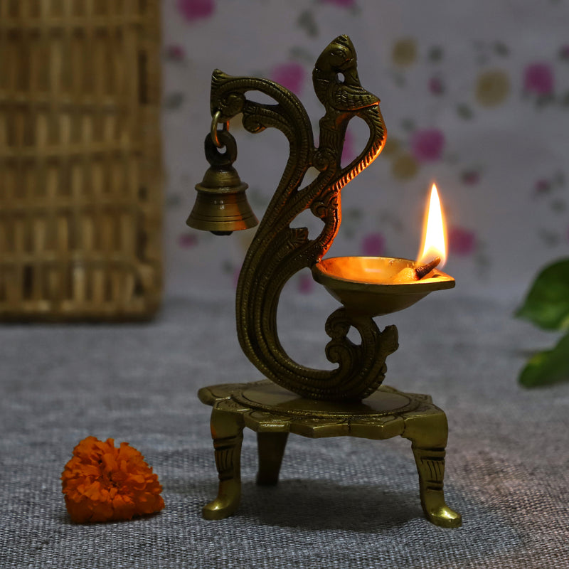 Brass peacock parrot Diya - exquisitely crafted brass oil lamp in the shape of a peacock with parrot motifs, golden finish, decorative home accent, fusion of elegance and vibrancy, traditional Indian Diya, emits a captivating and auspicious glow, perfect for festive occasions and religious ceremonies, enhances spiritual ambiance and decor with a touch of artistic brilliance.