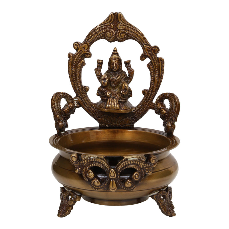 Brass Lakshmi & Ganesh Ji Urli - intricately crafted brass decorative bowl featuring idols of Goddess Lakshmi and Lord Ganesh, golden finish, traditional Indian Urli, versatile home accent, ideal for floating flower petals or candles, symbolizes prosperity and blessings, adds a touch of divinity and cultural richness to any space, perfect for creating an auspicious ambiance and enhancing interior decor, a timeless piece of art for both indoor and outdoor settings.