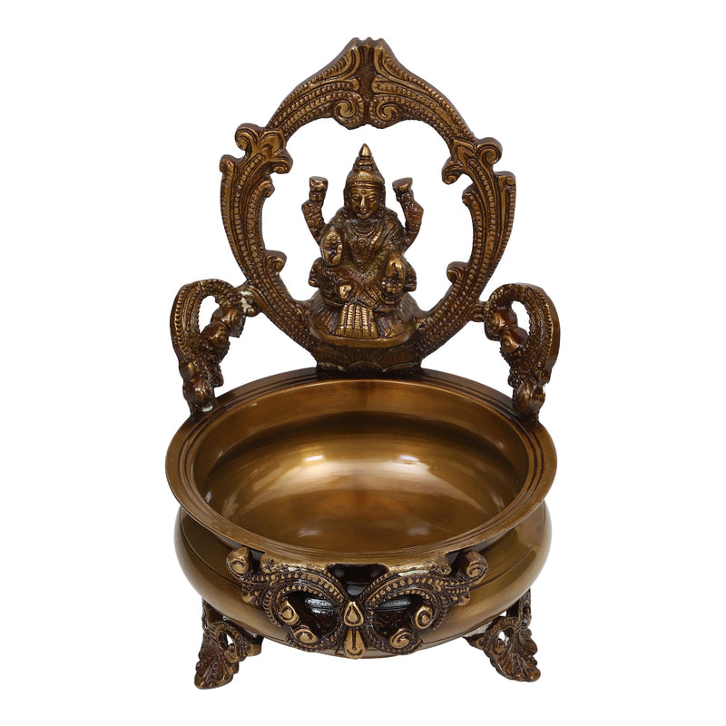 Brass Lakshmi & Ganesh Ji Urli - intricately crafted brass decorative bowl featuring idols of Goddess Lakshmi and Lord Ganesh, golden finish, traditional Indian Urli, versatile home accent, ideal for floating flower petals or candles, symbolizes prosperity and blessings, adds a touch of divinity and cultural richness to any space, perfect for creating an auspicious ambiance and enhancing interior decor, a timeless piece of art for both indoor and outdoor settings.