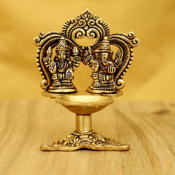 Brass Ganesha Lakshmi Diya - exquisitely crafted brass oil lamp featuring Lord Ganesha and Goddess Lakshmi, golden finish, decorative home accent, symbolizes prosperity and divine blessings, traditional Indian Diya, emits a radiant and auspicious glow, perfect for religious ceremonies and festive occasions, enhances spiritual ambiance and decor with the blessings of Ganesha and Lakshmi.