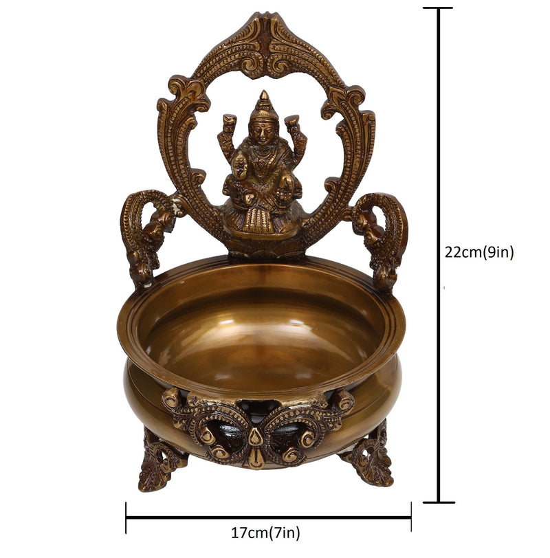 Brass Lakshmi & Ganesh Ji Urli - intricately crafted brass decorative bowl featuring idols of Goddess Lakshmi and Lord Ganesh, golden finish, traditional Indian Urli, versatile home accent, ideal for floating flower petals or candles, symbolizes prosperity and blessings, adds a touch of divinity and cultural richness to any space, perfect for creating an auspicious ambiance and enhancing interior decor, a timeless piece of art for both indoor and outdoor settings.