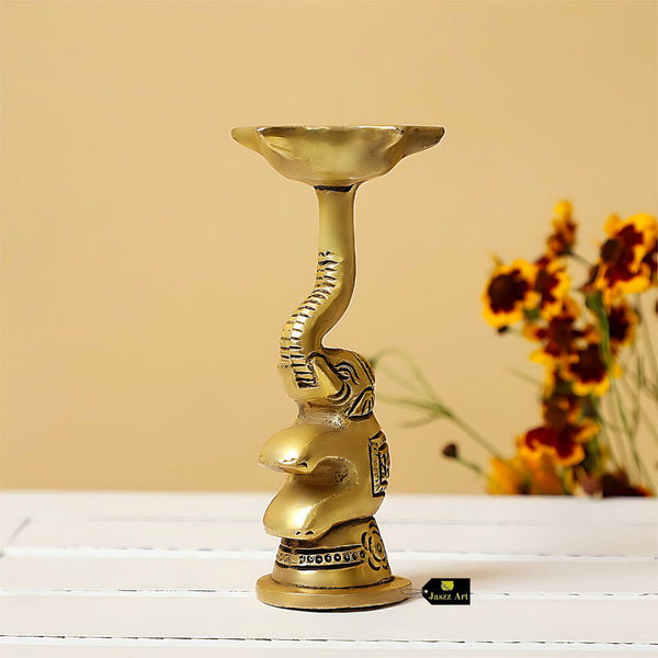 Brass Elephant Diya - intricately designed brass oil lamp in the shape of an elephant, golden finish, decorative home accent, symbolizes strength and wisdom, traditional Indian Diya, emits a warm and enchanting glow, ideal for religious ceremonies and festive occasions, enhances spiritual ambiance and decor