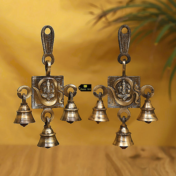 Brass OM Ganesh Ji Bells - beautifully crafted brass bells featuring the Om symbol and Lord Ganesh, golden finish, decorative home accent, emits a harmonious and auspicious sound, perfect for invoking divine blessings and creating a sacred atmosphere, ideal for meditation, worship, and spiritual practices, symbolizes the divine union of Om and Lord Ganesh, enhances the ambiance with positive vibrations and divine energy, a meaningful addition to your collection of brass artifacts