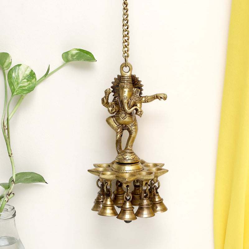 Brass Wall Diya - intricately designed brass oil lamp for wall mounting, golden finish, decorative home accent, traditional Indian Diya, emits a warm and inviting glow, ideal for enhancing wall decor and creating an ambiance of serenity, perfect for religious ceremonies and festive occasions, adds a touch of traditional charm to interior spaces.