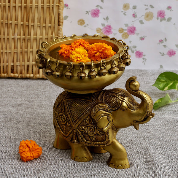 Brass Elephant Urli - meticulously designed brass decorative bowl featuring elephant motifs, golden finish, traditional Indian Urli, versatile home accent, ideal for floating flower petals or candles, symbolizes strength and wisdom, adds a touch of cultural charm and serenity to any space, perfect for creating an inviting ambiance and enhancing interior decor, a timeless piece of art for both indoor and outdoor settings.